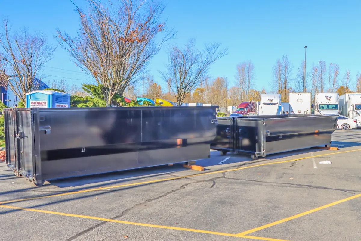 Professional dumpster rental service with roll-off container on residential driveway in Lumberton